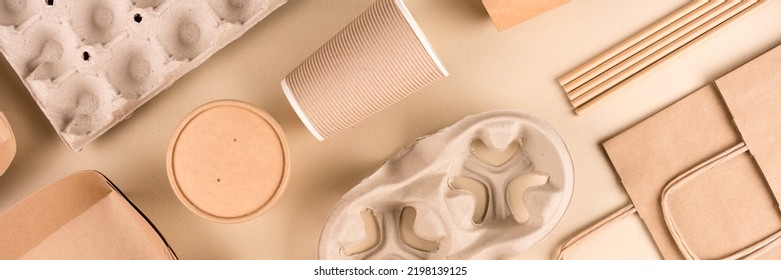 Banner with paper utensils over light brown background. Street food sustainable paper packaging. Eco- friendly food containers, cups and paper bags. Monochrome flat lay composition - Shutterstock ID 2198139125
