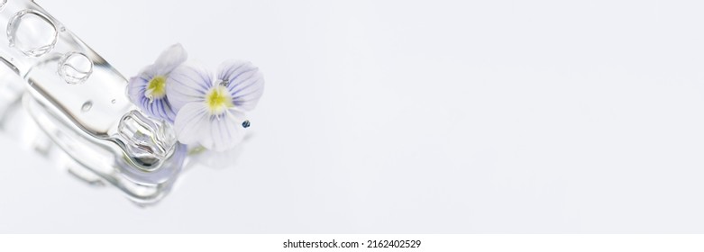 Banner With Pipette With Transparent Liquid On White Glass Background With Copy Space. Texture Of Face Serum Or Cosmetic Oil. Selective Focus, Macro Photo