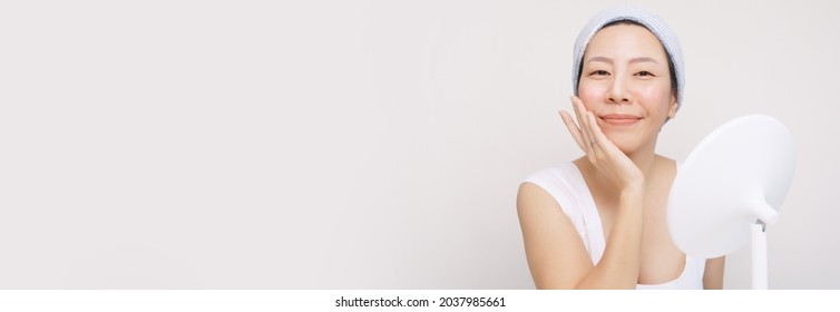 Banner Portrait Of A Beautiful Asian Woman With No Makeup Gently Touch Her Smooth, Soft And Clean Facial Skin And Smiling With Satisfying. K Beauty, No Makeup, Daily Skincare, Happy, Glowing, Clean.