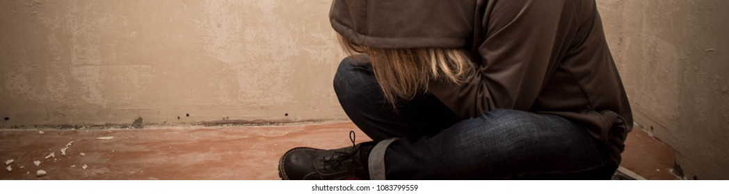 Banner of Portrait of man sad, drug addict man sitting on the floor in corner.