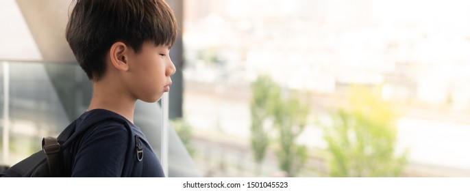 Banner Portrait Of A Smart Looking Asian Tween Student Boy Standing Alone At The School. Bullying, Physical Or Emotional Harm, Loneliness, Withdrawn, Teen Problems, Mood Swings, Puberty, Hormones.