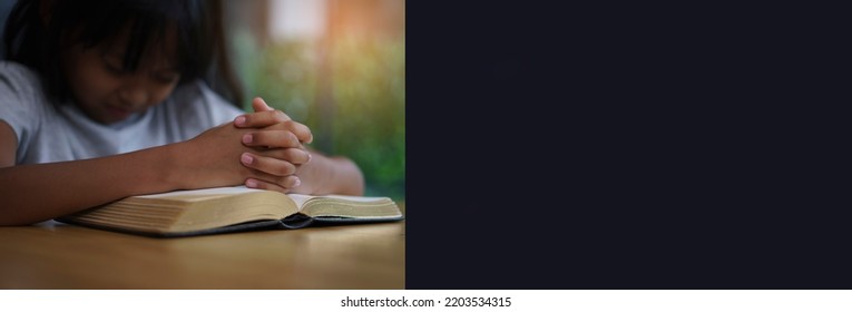 Banner Of Prayer And Bible Concept. Asian Kid Praying, Hope For Peace And Free From War And Coronavirus, Hand In Hand Together By Child. Little Girl Believes And Faith In Christian Religion At Church.