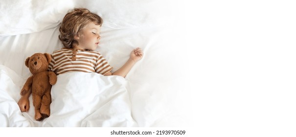 Banner sleeping baby boy on pillow with blanket in bed with white clean cotton bed linen  - Shutterstock ID 2193970509