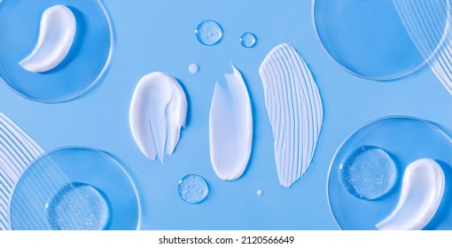 banner smear of cream round transparent drop of banner transparent gel serum in a petri dish on a blue background	
				