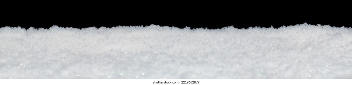 Banner of sparkling fluffy white snow isolated on black