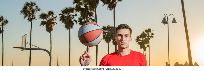 Banner Of Sports Man Hold Basketball Ball On Venice Beach Basketball Court. Hand Spinning Basket Ball. Balancing Basketball On Finger.