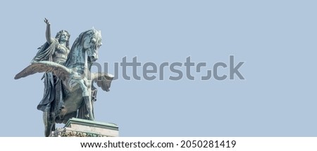 Banner with statue of Greek goddess Muse riding winged horse Pegasus in historical, touristic downtown in Vienna Austria at blue sky background and copy space. Concept of Cultural Heritage and Travel