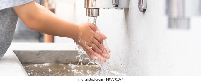 Banner Of A Student Boy Wash Hands At The Outdoor Wash Basin In The School. Preventing Contagious Diseases, Plague. Kids Health, Hygiene, Flu, H5N1 Influenza, Saving Water, Covid-19, New Normal.