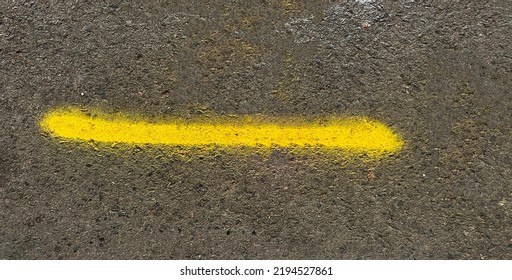 Banner style asphalt concrete urban road texture with yellow spray paint swoosh line 