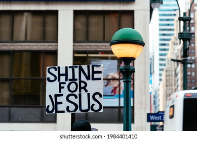 Banner With The Text Shine For Jesus Besides Street Lamp In New York City