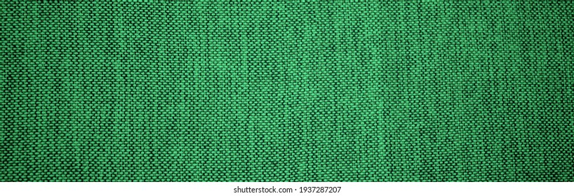 Banner of texture of green natural linen fabric. St Patricks Day abstract wallpaper. Used like background.
