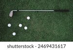 Banner top view of a green lawn on which lies a white balls and a metal golf club. Professional golf game at a country club advertisement. Free space for text. Golf equipment. Luxury summer sport.