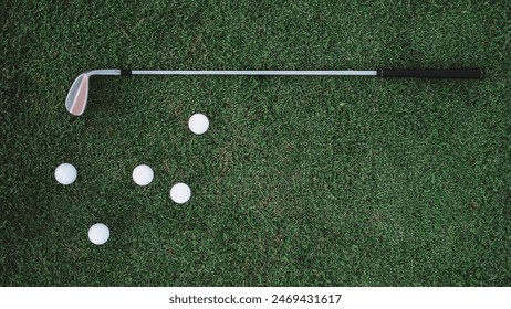 Banner top view of a green lawn on which lies a white balls and a metal golf club. Professional golf game at a country club advertisement. Free space for text. Golf equipment. Luxury summer sport. - Powered by Shutterstock