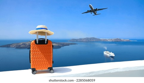 Banner of travel concept with Orange luggage and hat as landscape view of Oia town in Santorini island in Greece , Greek landscape as blue sky background