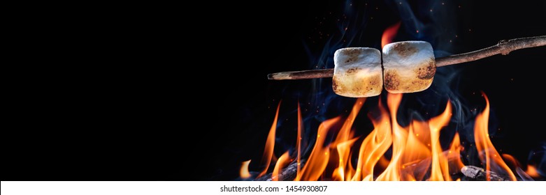 Banner Of Two Marshmallows On A Stick Roasting Over Campfire On Black Background - Camping/Summer Fun Concept