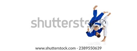 Banner. Two men judoist training, fighting showing technical skill isolated white studio background. Concept of martial art, combat sport, health, strength, energy, fit. Copy space