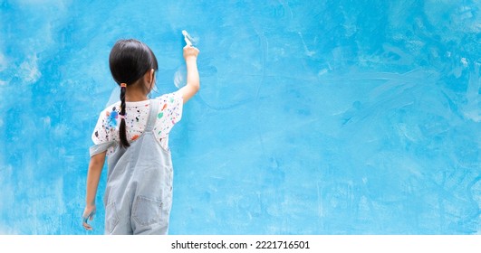 Banner Unidentified Asian Little Girl Is  Painting The Wall With Water Color At Home, Concept Of Art Education For Kid, Homeschooling And Learning Activity By Playing For Child.