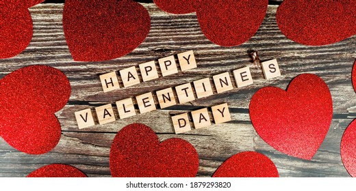 Banner. Valentine's Day. happy valentine's day inscription with red hearts on wooden background. The concept of celebration and love. - Shutterstock ID 1879293820