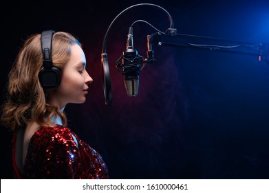 Banner For Vocal Lessons And Music. A Professional Singer Sings Into A Studio Microphone. Screensaver For Karaoke And Vocal Mastery. Music Schools And Music Training