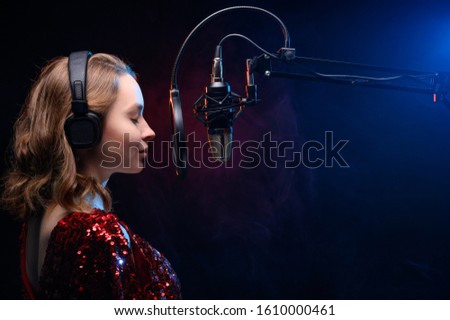 Banner for vocal lessons and music. A professional singer sings into a studio microphone. Screensaver for karaoke and vocal mastery. Music schools and music training