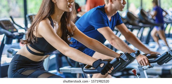 Banner, web page or cover template of Couple young diversity working out in gym fitness sport complex, workout working out bicycle and cardio, spinning class, sports and healthcare concept - Powered by Shutterstock