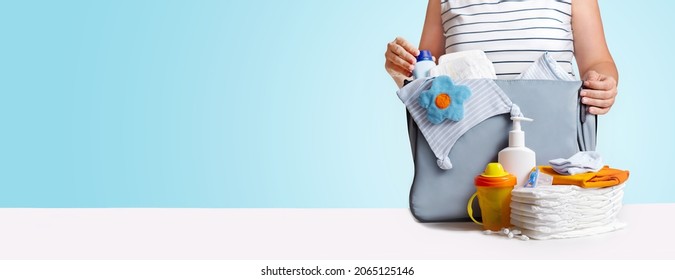 Banner. Woman Packing Diaper Bag On Blue.