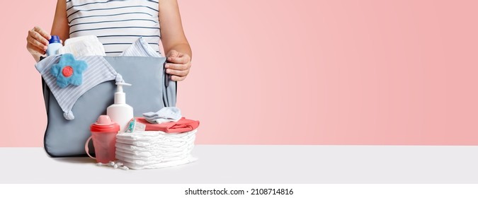 Banner. Woman Packing Diaper Bag On Pink.