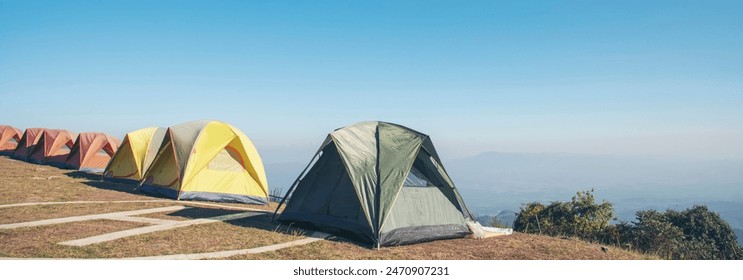 Banner Women camping outdoor sitting Tent Camp trip hiking mountain hill on sunrise. Panorama Tent camp nature background flare sunlight mountain. Picnic green Adventure Travel forest with copy space - Powered by Shutterstock