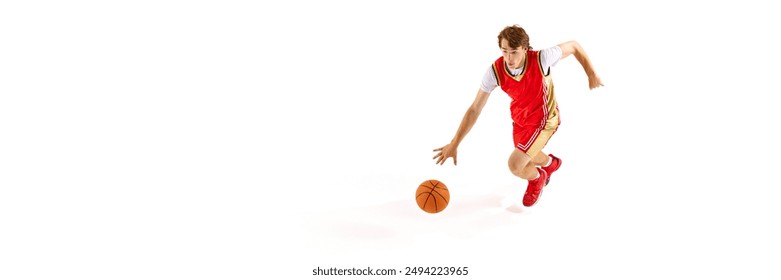 Banner. Young basketball athlete dribbling in motion against white studio background with negative space to inset text. Concept of professional sport, competition, match, team games. Ad - Powered by Shutterstock