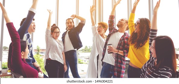 Banner Of Young Multiethnic Diverse Creative Asian Group Huddle And High Five Hands Together In Office Workshop With Success Or Empower Expression In Teamwork. Young Asian Marketing Team.