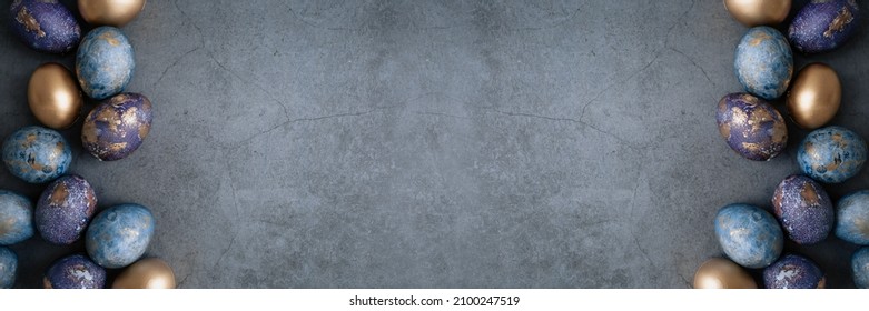 Banner.Easter card with a copy of the place for the text. Purple, blue and golden eggs on a dark background. The purple hue trend of 2022 is very relevant. Natural dye karkade tea. Top view. - Powered by Shutterstock