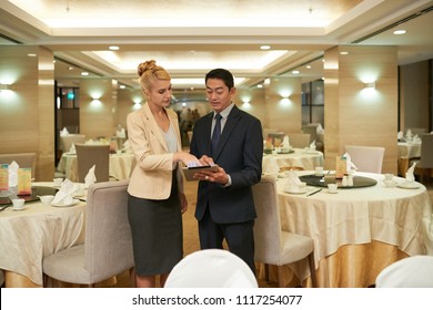 Banquet Manager And Restaurant Owner Discussing Upcoming Event