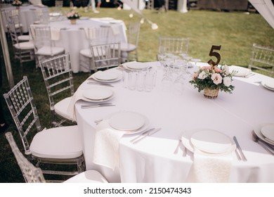 Banquet Table Setting Under A White Tent On The Grass