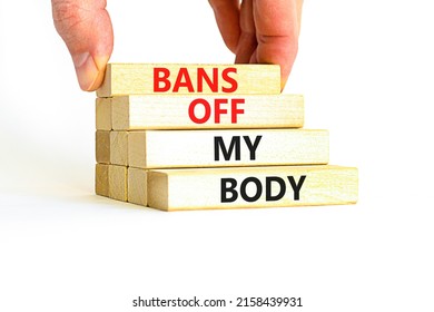 Bans off my body symbol. Concept words Bans off my body on wooden blocks on a beautiful white table white background. Women rights concept. Business social issues and bans off my body concept.