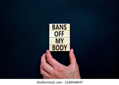 Bans off my body symbol. Concept words Bans off my body on wooden blocks on a beautiful black table black background. Women rights concept. Business social issues and bans off my body concept.