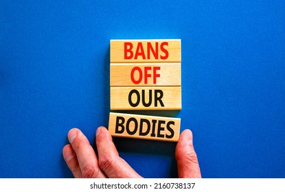 Bans off our bodies symbol. Concept words Bans off our bodies on wooden blocks on beautiful blue table blue background. Women rights concept. Business social issues and bans off our bodies concept.