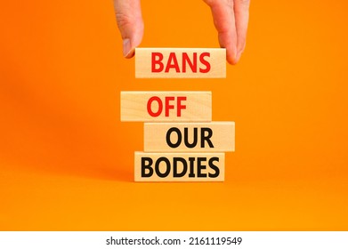 Bans off our bodies symbol. Concept words Bans off our bodies on wooden blocks on beautiful orange table orange background. Women rights concept. Business social issues bans off our bodies concept.