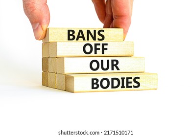 Bans off our bodies symbol. Concept words Bans off our bodies on wooden blocks on beautiful white table white background. Women rights concept. Business social issues and bans off our bodies concept.