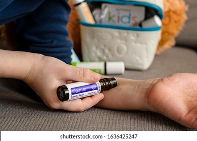 Banska Bystrica, Slovakia - February 2nd 2020: High Quality Essential Oils In Kids Collection, Doterra Brand. Child Applying Calmer Oil. Healthcare And Wellbeing Concept. Aromatherapy.