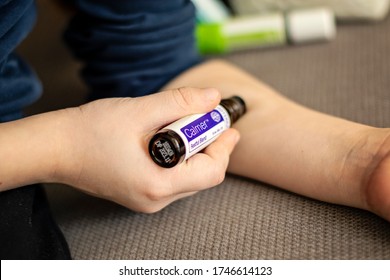 Banska Bystrica, Slovakia - February 2nd 2020: High Quality Essential Oils In Kids Collection, Doterra Brand. Child Applying Calmer Oil. Healthcare And Wellbeing Concept. Aromatherapy.