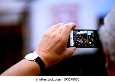 BANSKO, BULGARIA - MARCH 05, 2017: Unqnown Man Filming Live Event With His Iphone Smartphone 