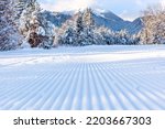 Bansko, Bulgaria perspective of freshly groomed ski run slope and defocused mountain peak