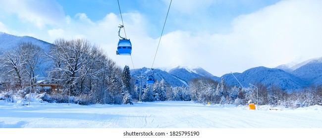 Bansko, Bulgaria winter ski resort with ski slope, lift cabins, and mountains view banner background - Powered by Shutterstock