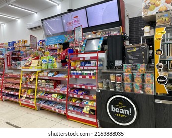 Banten, Indonesia - June 4, 2022: Cash Register Area Of A Local Grocery Store With Displays Of Various Promoted Items And Overhead Displays.