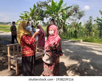 Bantul, Indonesia March 18, 2021, Guests Who Attended The Wedding During The Covid 19 Period, Their Body Temperature Was Measured By The Receptionist