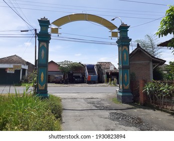 Bantul, Indonesia March 7, 2021 Gate Of A Hamlet In The Background Of A Dumb Truck Being Repaired