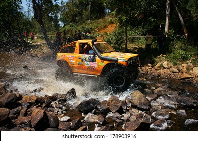 BAO LOC, VIETNAM- FEB 24, 2014: Racer at terrain racing car competition,motor cross stream that extreme off road with rock on water, competitor  adventure in championship spirit, Viet Nam