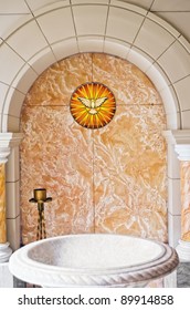 Baptismal Area Inside Catholic Church With The Holy Spirit And Water Basin