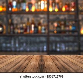 Bar with blurred lights bokeh and wooden table