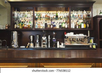 Bar Counter With Alcohol Bottles Assortment. Barroom In Restaurant, Hotel, Pub Copy Space. Cafe Background